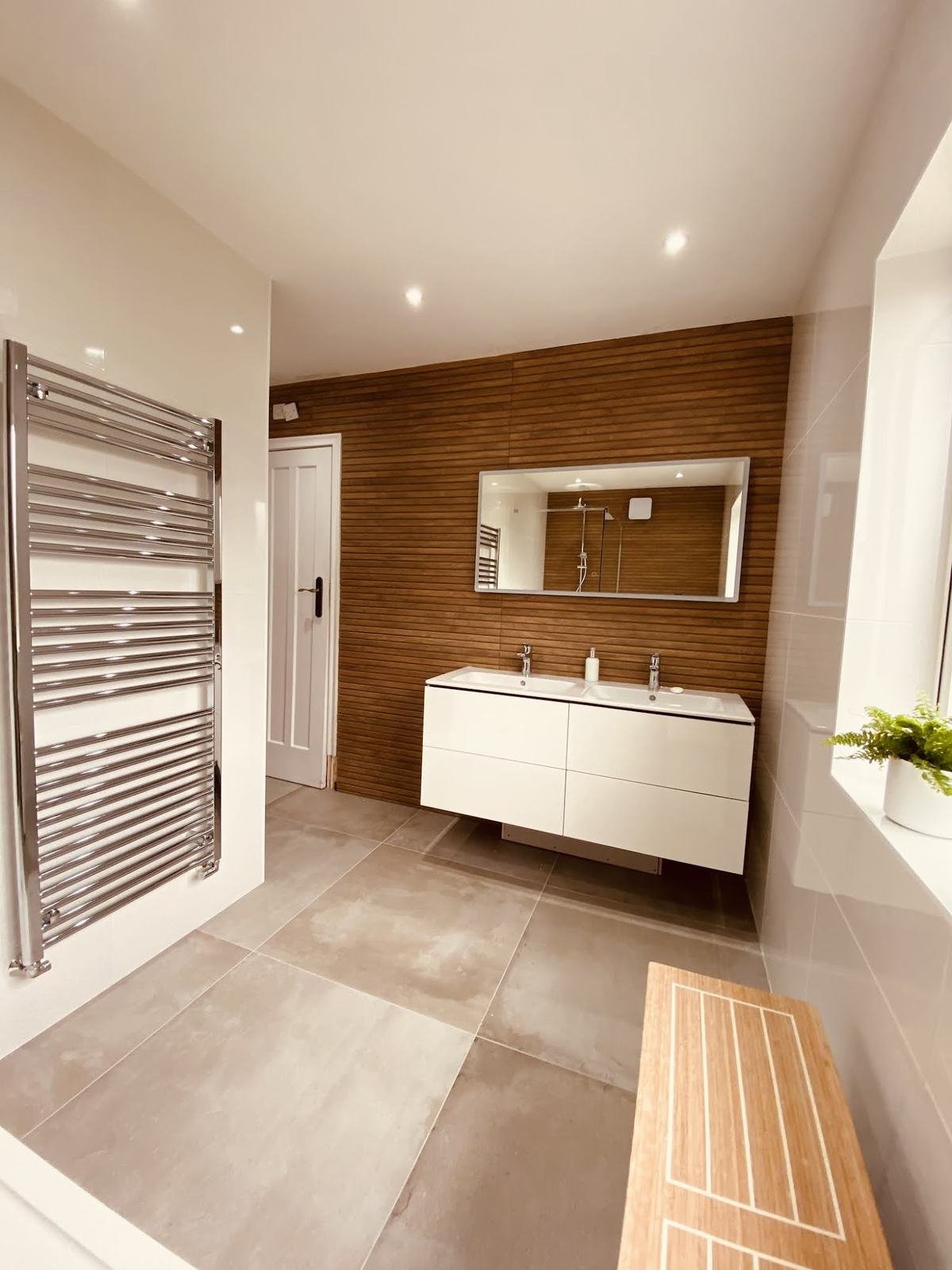 Finished bathroom with large-format floor and wood-effect wall, from Nik's review