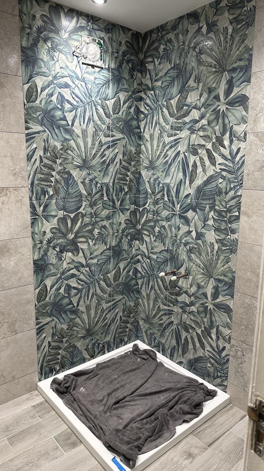 Shower room with a botanical-print feature wall, from Alison's review