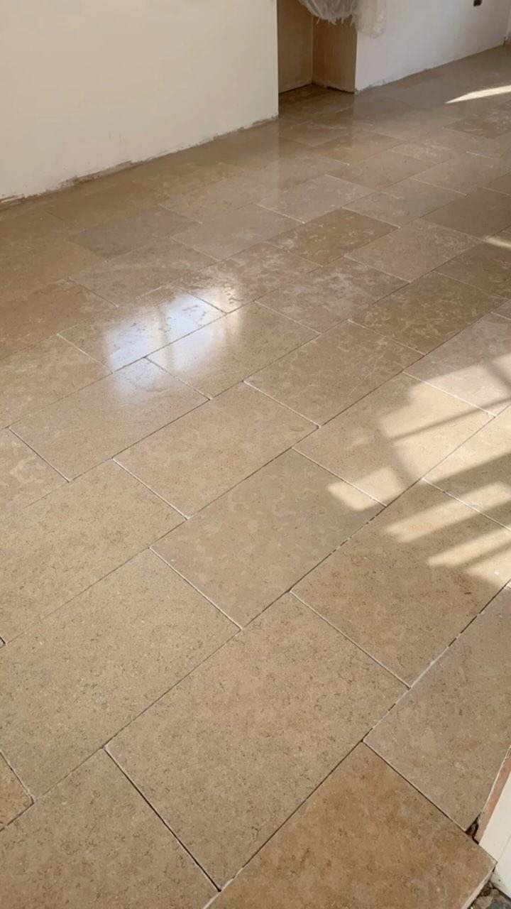 Polished limestone kitchen floor catching the light