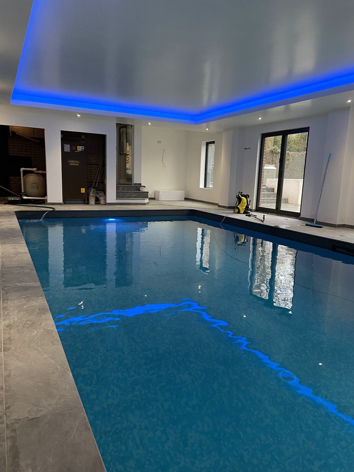 Indoor swimming pool with a grey natural stone surround