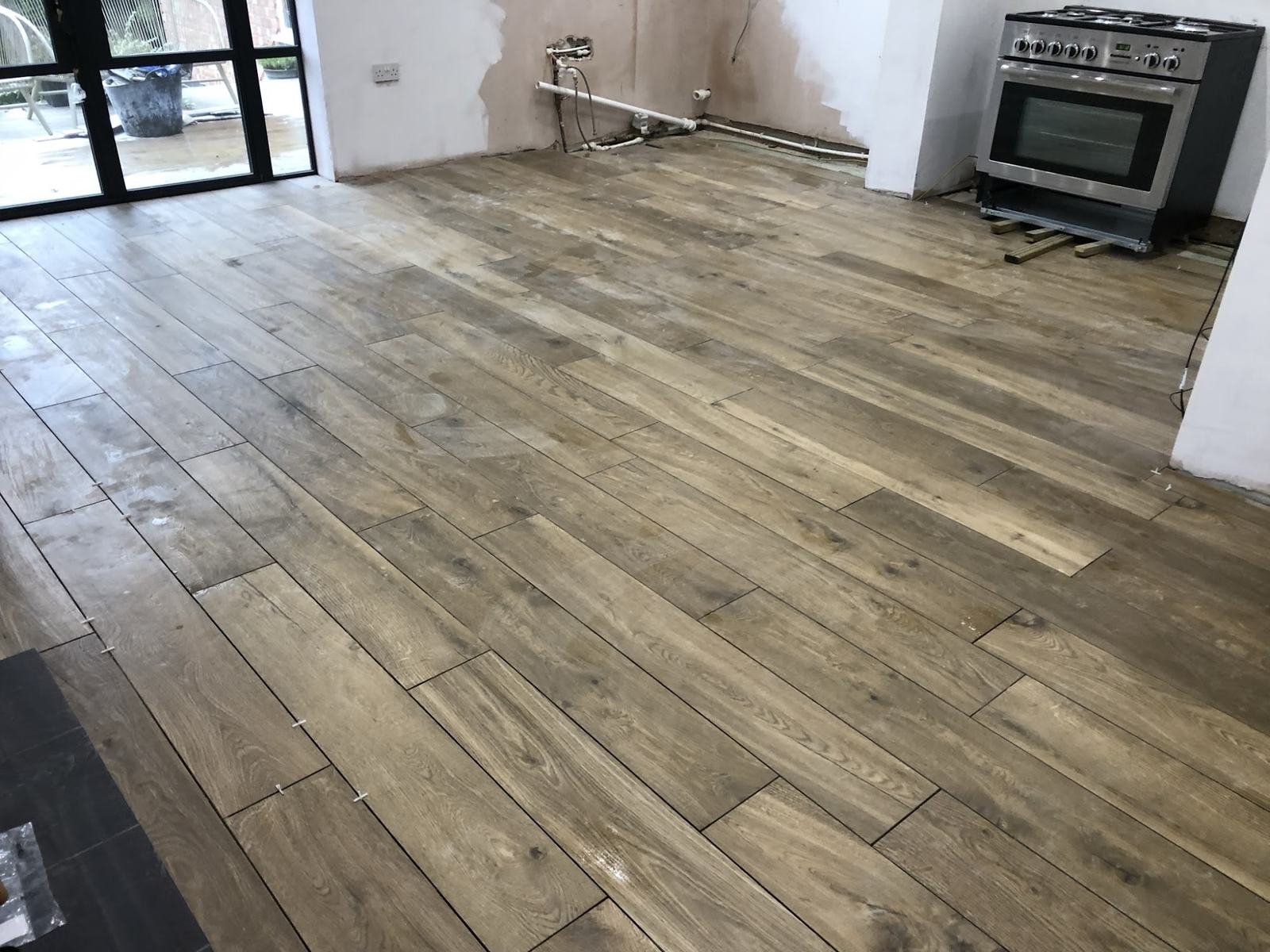After: the same kitchen with wood-effect porcelain planks laid