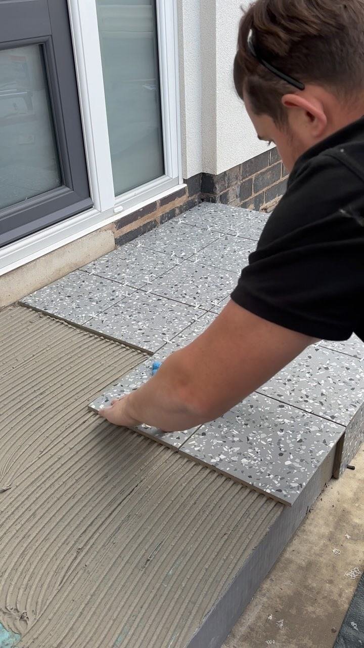 Terrazzo tiles being fitted to a front step