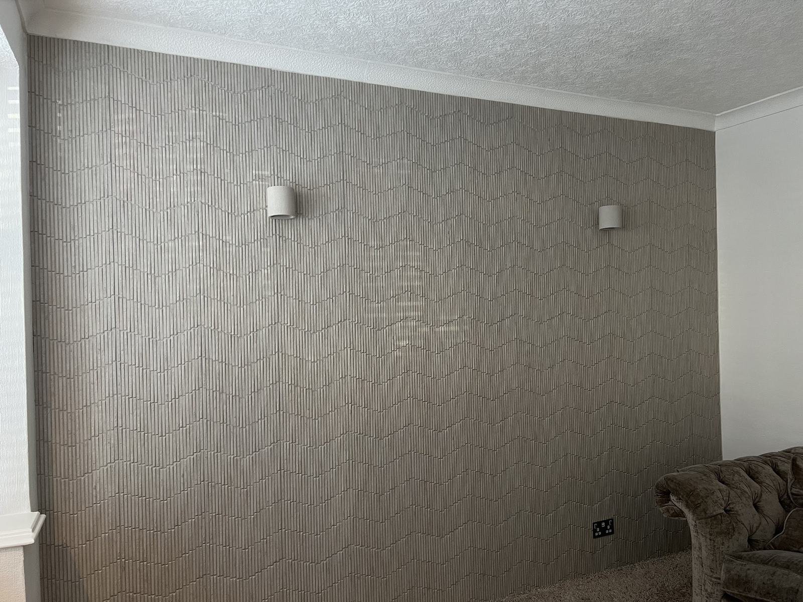 Textured chevron tiled wall with the wall lights off