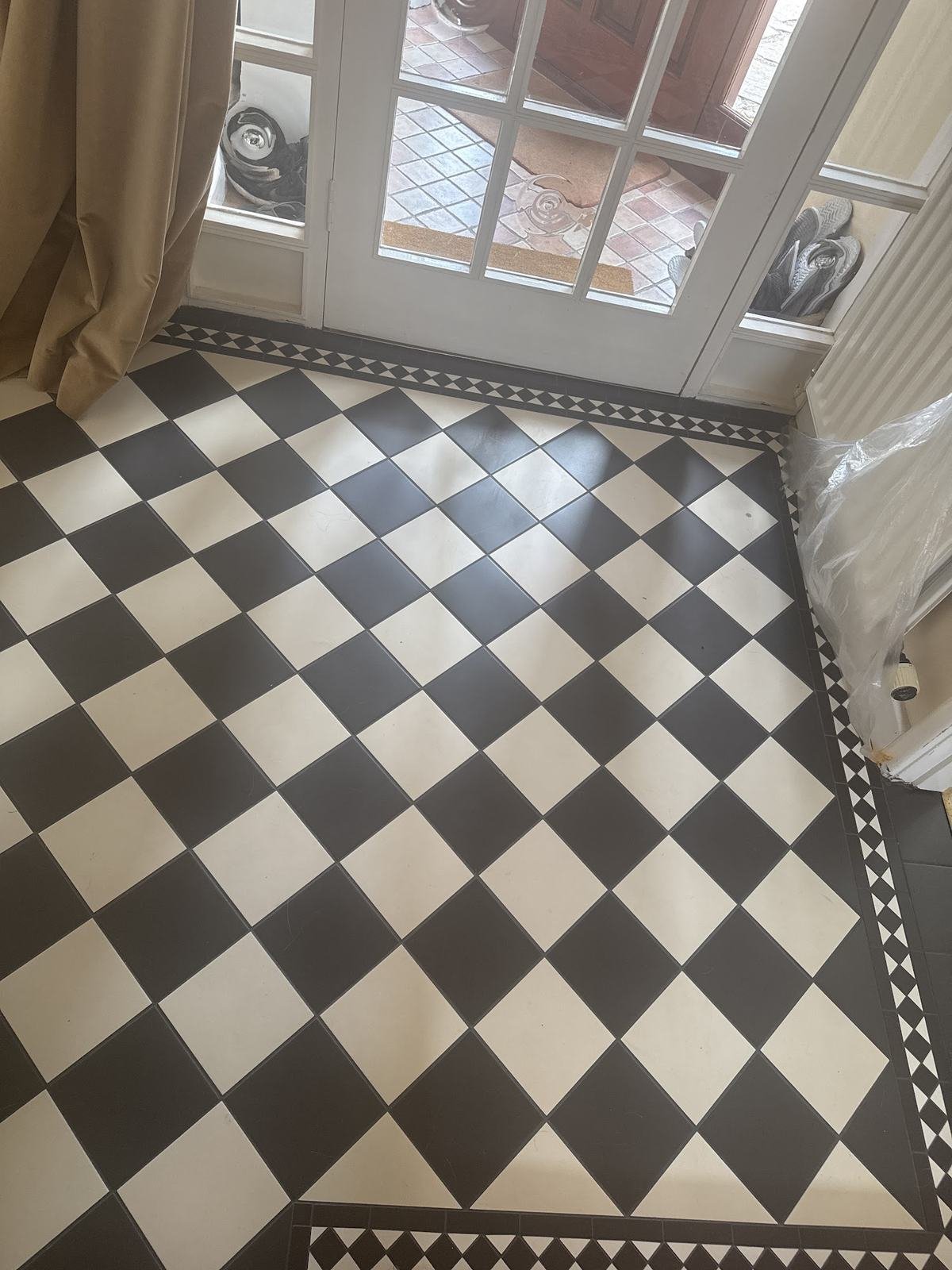 Chequerboard floor with a border at a front door, from Gulnaz's review